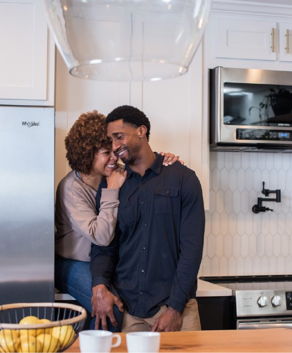 couple in the kitchen hugging eachother